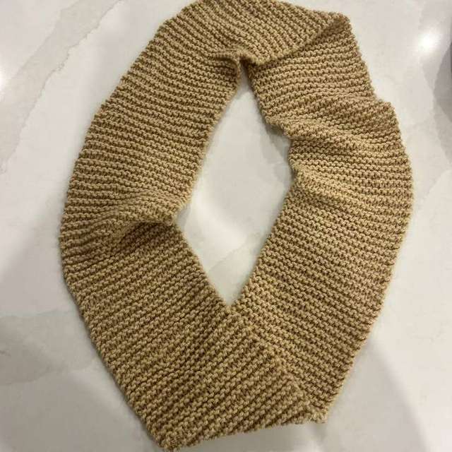 Handmade camel crochet cowl scarf laid flat